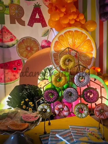 A donut wall is a fun and interactive treat station that adds another layer of fun to the party, with donuts decorated to match the fruity theme.