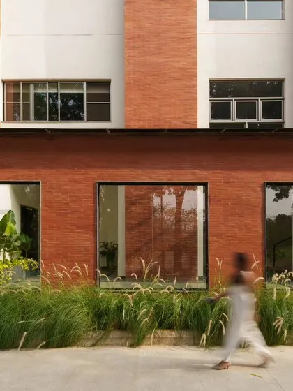 The entryway to the office block at Campus Biovet, where simple lines of brick, granite, glass, and grass create a stunning composition. This demonstrates our belief in achieving powerful design through a minimal palette of natural materials.