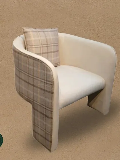 A modern armchair with a unique T-shaped back and a subtle plaid pattern. This chair combines a contemporary silhouette with a classic fabric for a truly distinctive look.