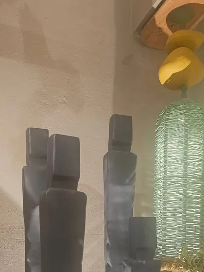A pair of abstract, modern human-figure sculptures. These pieces are perfect for adding a touch of sophistication to a contemporary garden or interior space.