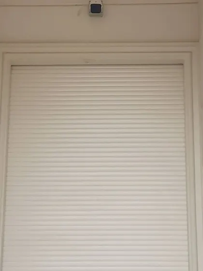 Here is a security sensor installed above a shop's rolling shutter. This is a key part of my wireless alarm system for businesses. If anyone tries to open the shutter after hours, the alarm will trigger and you get an instant call and SMS on your phone.