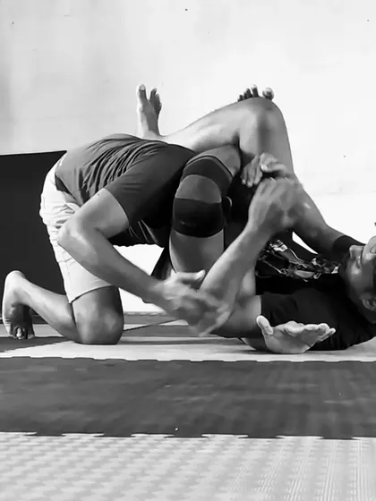 A black and white shot of a No-Gi roll, working from the guard. This is where the chess match of BJJ happens, fighting for position and submission.