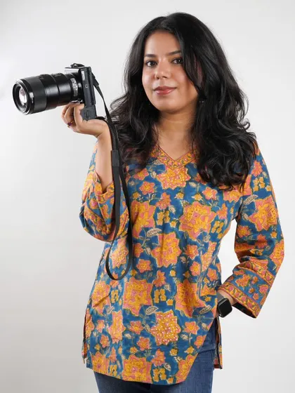 A portrait of me with my camera. I believe my ADHD is my creative superpower, keeping me energized and innovative on every shoot.