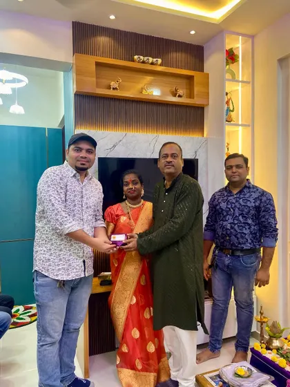 Handing over the keys to the Chalke family in their new 2BHK home. The TV unit in the background provides a beautiful focal point for their living room.