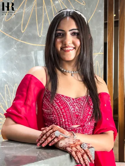 The complete look, showcasing the beautiful hair, makeup, and traditional henna. She is ready to turn heads at her event.