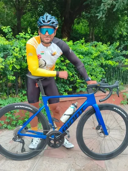 A rider posing with his high-performance Giant road bike. We appreciate all kinds of beautiful machines.