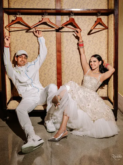 Pure fun and personality in this shot from the after-party. Amala and Aditya's playful dynamic is perfectly captured in this unconventional wedding portrait.
