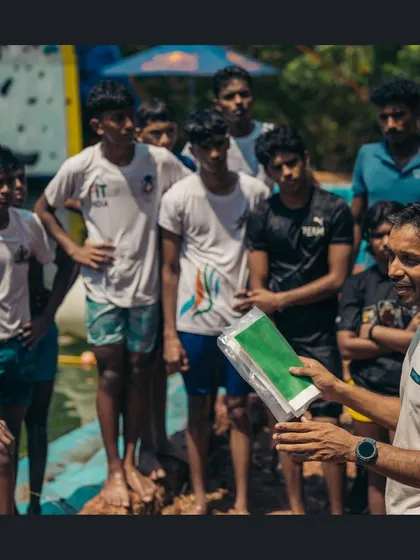 Our coach, Partha, explains the principles of water safety to a group of climbers. We ensure everyone understands the risks and techniques before the competition begins.