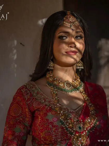 A sun-kissed portrait of the model in the banarasi lehenga, showing the richness of the colors.