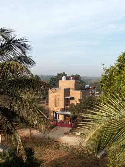 The Eesha residence seen through the trees, appearing as a natural extension of the landscape.