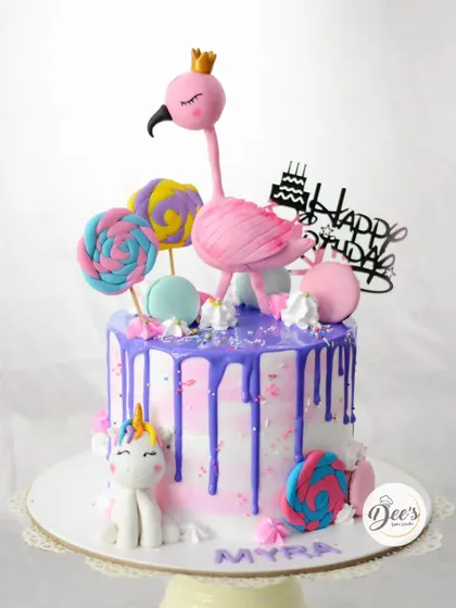 A magical combination of a flamingo and a unicorn on this drip cake makes for a whimsical and colorful birthday celebration.