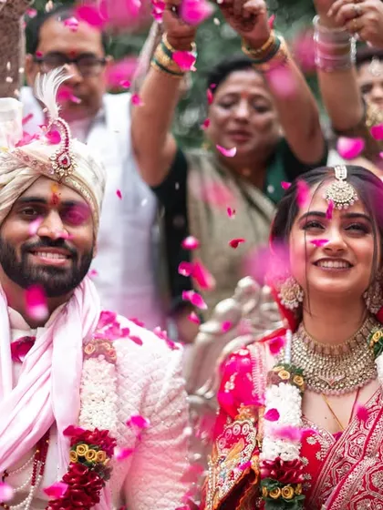 A beautiful shower of pink petals over the happy couple.