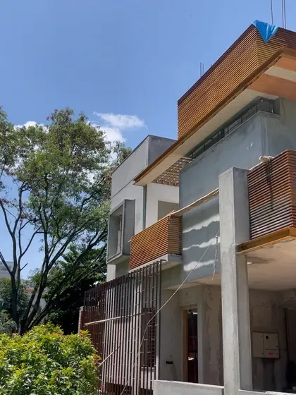 A detail of the facade with its wooden louvered railings.