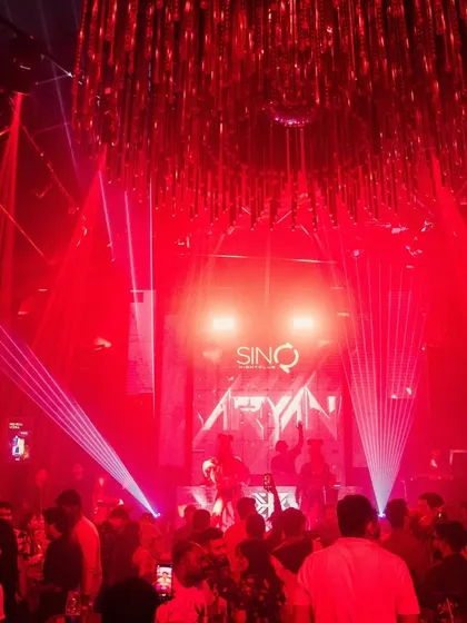 The stunning red-lit interior of Sinq, with my stage at the center of it all. This photo shows the grand scale of the club's production.