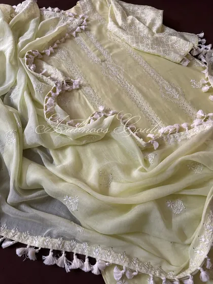 This image captures the movement of the soft dupatta and its delicate tassel details.