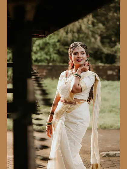 A lovely portrait of the bride in a traditional setting, framed in a warm brown border.