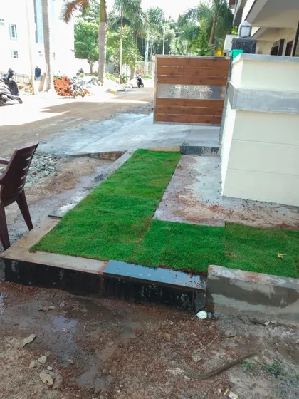 A new patch of lawn being installed at the entrance of a residence. Even small strips of land can be converted into welcoming green spaces with the right turf selection and professional installation.