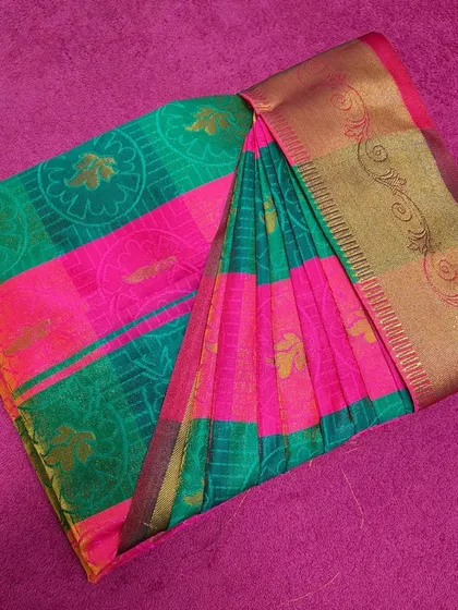 A vibrant pink and green saree, expertly box-folded. My packing ensures the saree remains wrinkle-free and the pleats stay in place.