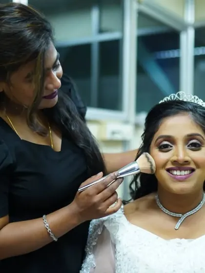Here I am, adding the finishing touches. For this Christian bridal look, I used a soft-bristle brush to apply a light layer of powder, ensuring her makeup stays flawless all day.