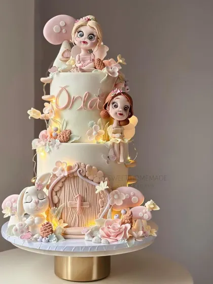 A magical, multi-tiered fairy-themed cake with lights and intricate details.