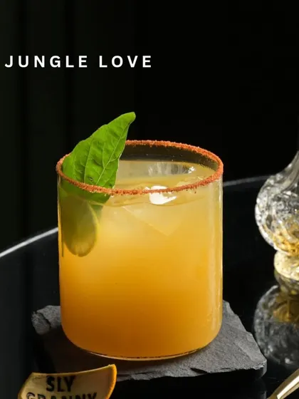 Jungle Love is a walk on the wild side. This cocktail balances sweet, savory, and spicy notes, with a chili-salt rim for an extra kick.