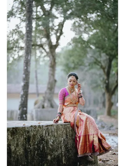 A bride looking serene and beautiful on her wedding day in a custom-designed saree and blouse.