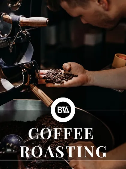 A close-up of a coffee roaster, representing the crucial roasting stage in the coffee's journey.