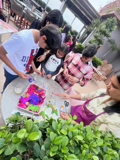 An instructor guides a group of kids as they create butterfly-themed crafts. We provide hands-on assistance to ensure every child, regardless of age, can participate and feel proud of their artwork.