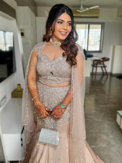 This hairstyle is perfect for a reception or engagement party. The soft curls add a touch of romance to the glamorous outfit.