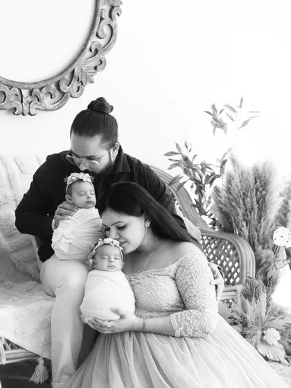 The same beautiful family with their newborn twins, presented in a timeless black and white edit that emphasizes the emotion and connection.