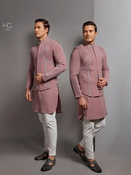 Redefining tradition with grace. This dusty rose Indo-Western set features a layered, structured jacket over a matching kurta, creating a soft yet strong silhouette.