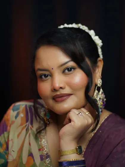A close-up of the festive glam look, showing the warm blush, defined eyes, and matte lipstick. The gajra in the hair completes this beautiful traditional style.