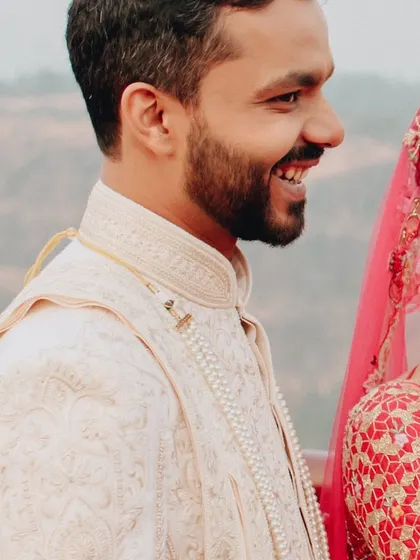 A candid shot of the groom, smiling and happy on his wedding day. We believe in capturing the groom's moments just as much as the bride's.