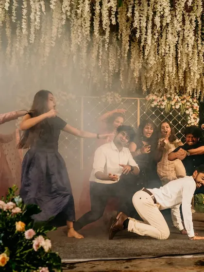 A high-energy moment from a reception in Bangalore, where friends took over the stage with a fun, smoky performance. This is the vibe we love to create.