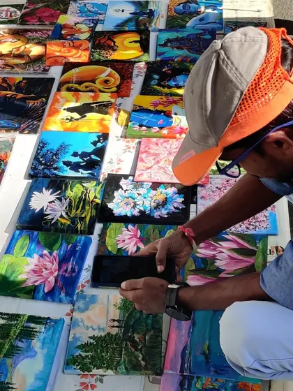 My collection of tiny paintings spread out at Chitra Santhe, attracting art admirers of all ages. These small canvases are a great way to start your art collection.