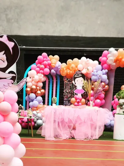 The main party area for the Ballerina theme, featuring a gorgeous pink tulle table skirt and a multi-colored balloon backdrop.