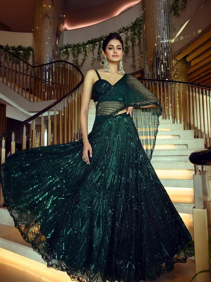 A duplicate of image 30, this full-length shot captures the dramatic flair of the emerald green lehenga styled for Manasa Varanasi's magazine cover shoot.