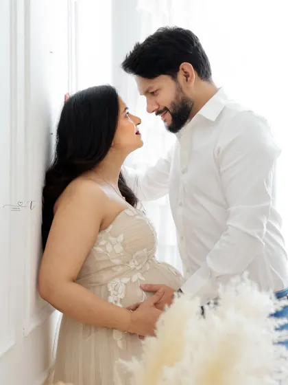 A moment of pure connection. This close-up shot captures the loving gaze between the expecting couple, with soft lighting enhancing the romantic mood.