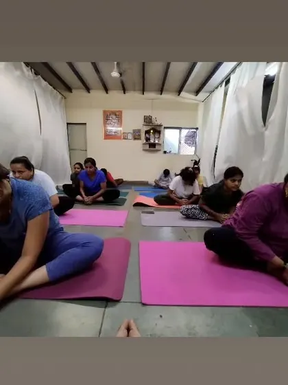Students in a seated forward bend, Baddha Konasana (Bound Angle Pose). This posture helps release tension in the inner thighs and groin, and we focus on breathing into the stretch.