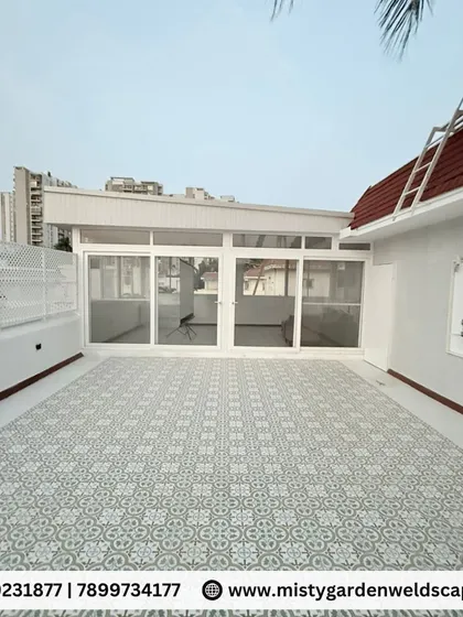 A frontal view of the enclosed terrace, showing the large UPVC sliding doors that open up to the patio, effectively blending the indoor and outdoor spaces.
