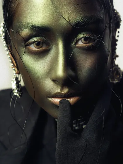 An intense close-up with metallic green body paint. This conceptual beauty shot is all about texture, color, and a captivating gaze.