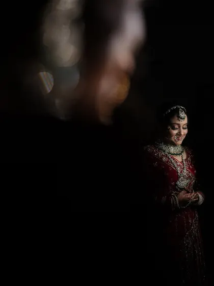 An artistic and moody bridal portrait using creative lighting effects. This low-light shot creates a sense of mystery and elegance.