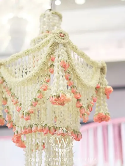 An enchanting chandelier made entirely of fragrant jasmine (mogra) and delicate pink lotuses. This was a stunning centerpiece for a traditional half-saree function, filling the air with a beautiful scent.