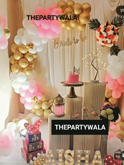 A beautiful "Bride to be" party decoration. The pink, white, and gold balloon arch with a custom banner is a perfect way to celebrate the future bride.