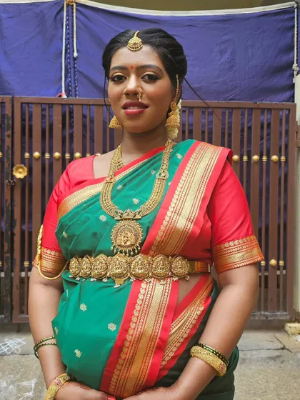 A full-length shot of Prakruthi in her beautiful green and red silk saree.