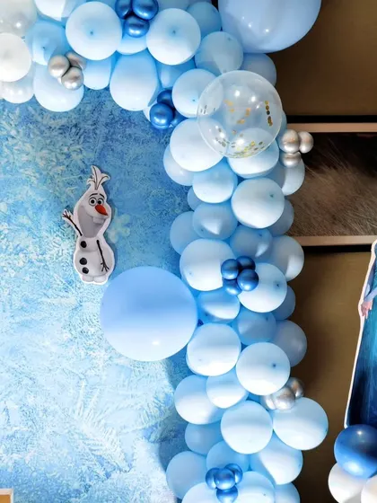 A beautiful balloon arch in shades of icy blue and white for the Frozen theme.