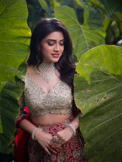 Mahima looking down, showcasing her soft glam eyeshadow. The makeup is subtle yet effective, creating a look of effortless elegance.