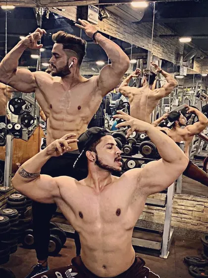 Having fun with a mirror shot in the gym. Posing helps you connect with your muscles and appreciate the progress you've made.