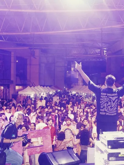 A view from behind the decks, looking out at a sea of people at an outdoor festival. This is the scale of events I am comfortable and experienced with.