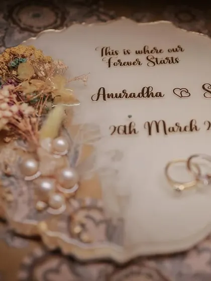A beautiful flat-lay of the wedding rings on a custom invitation plaque. We believe in capturing all the little details that make your day special.